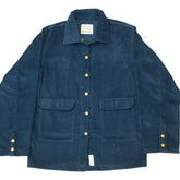 Folded blue jacket with gold buttons on a white surface